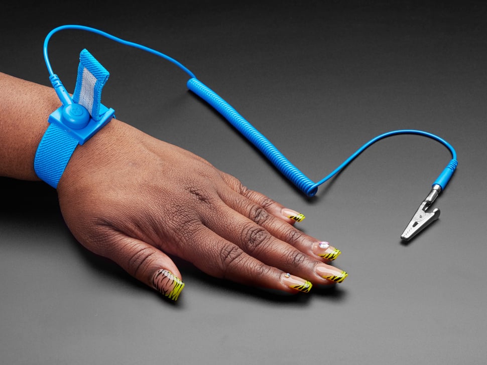 A person wearing an-anti static wrist strap while working inside an open desktop computer case